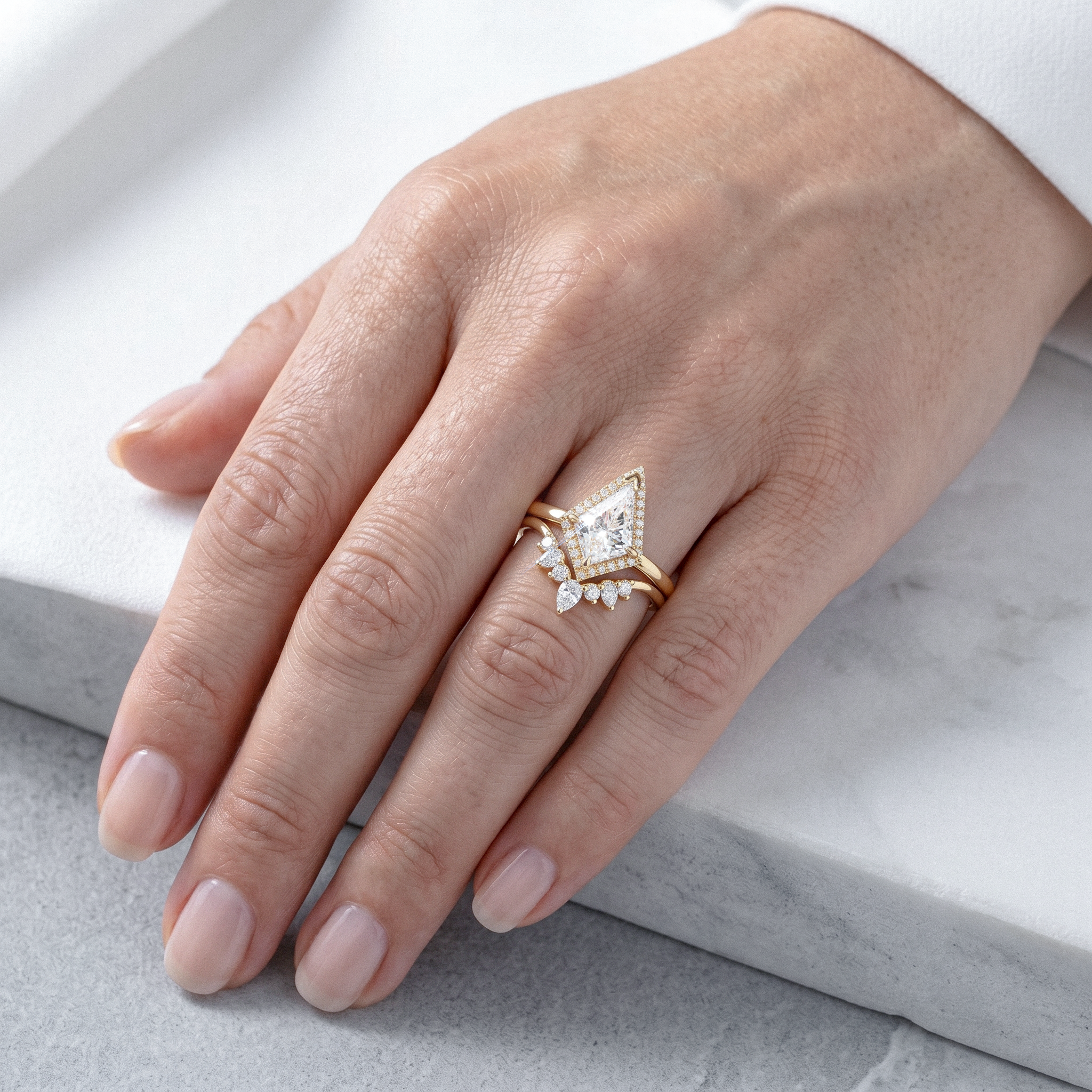 Hand wearing a golden kite shape diamond ring set 2pcs  on a light background