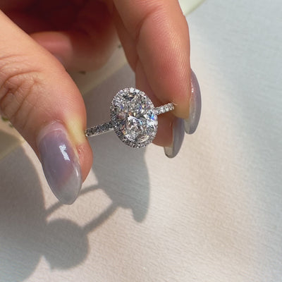 halo oval diamond ring with pave band on hand
