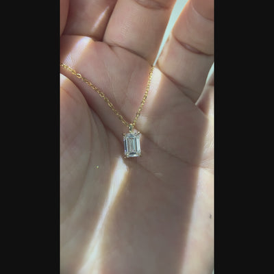 Video showing an emerald-cut solitaire pendant from multiple angles.