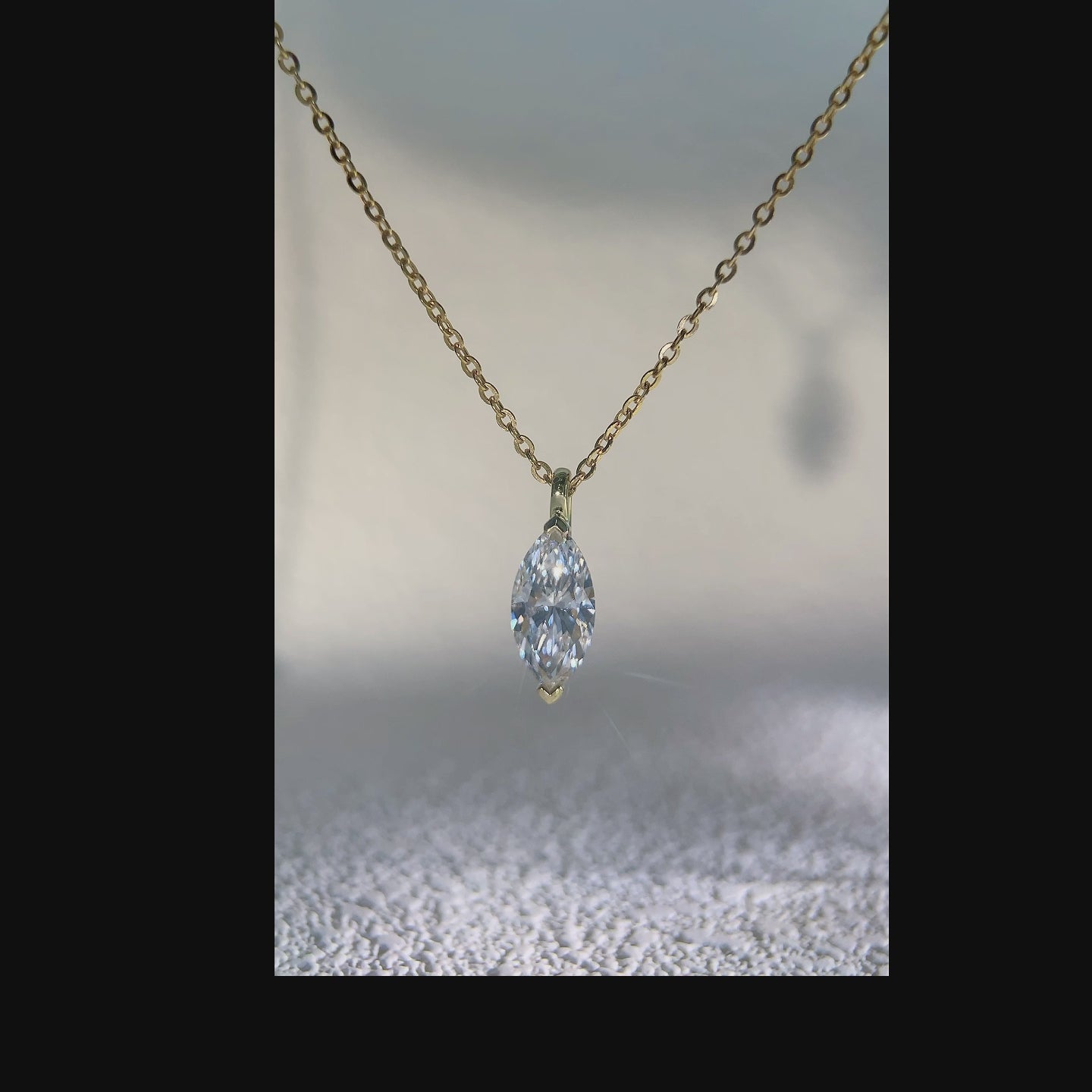 Video showing a marquise-cut solitaire pendant from multiple angles.