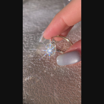 Pear -cut halo diamond ring with side stones