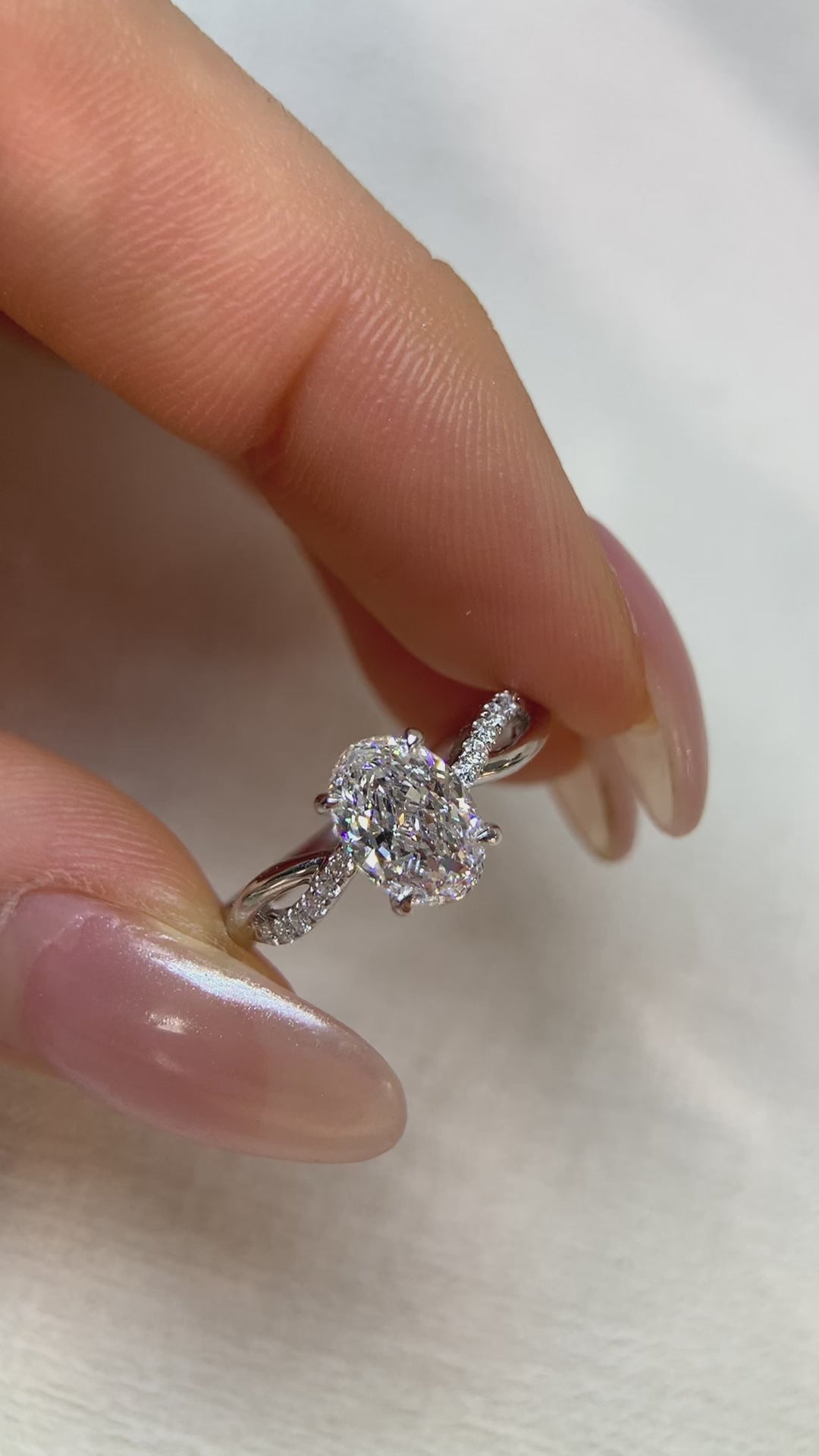 white gold oval cut diamond ring with twisted band