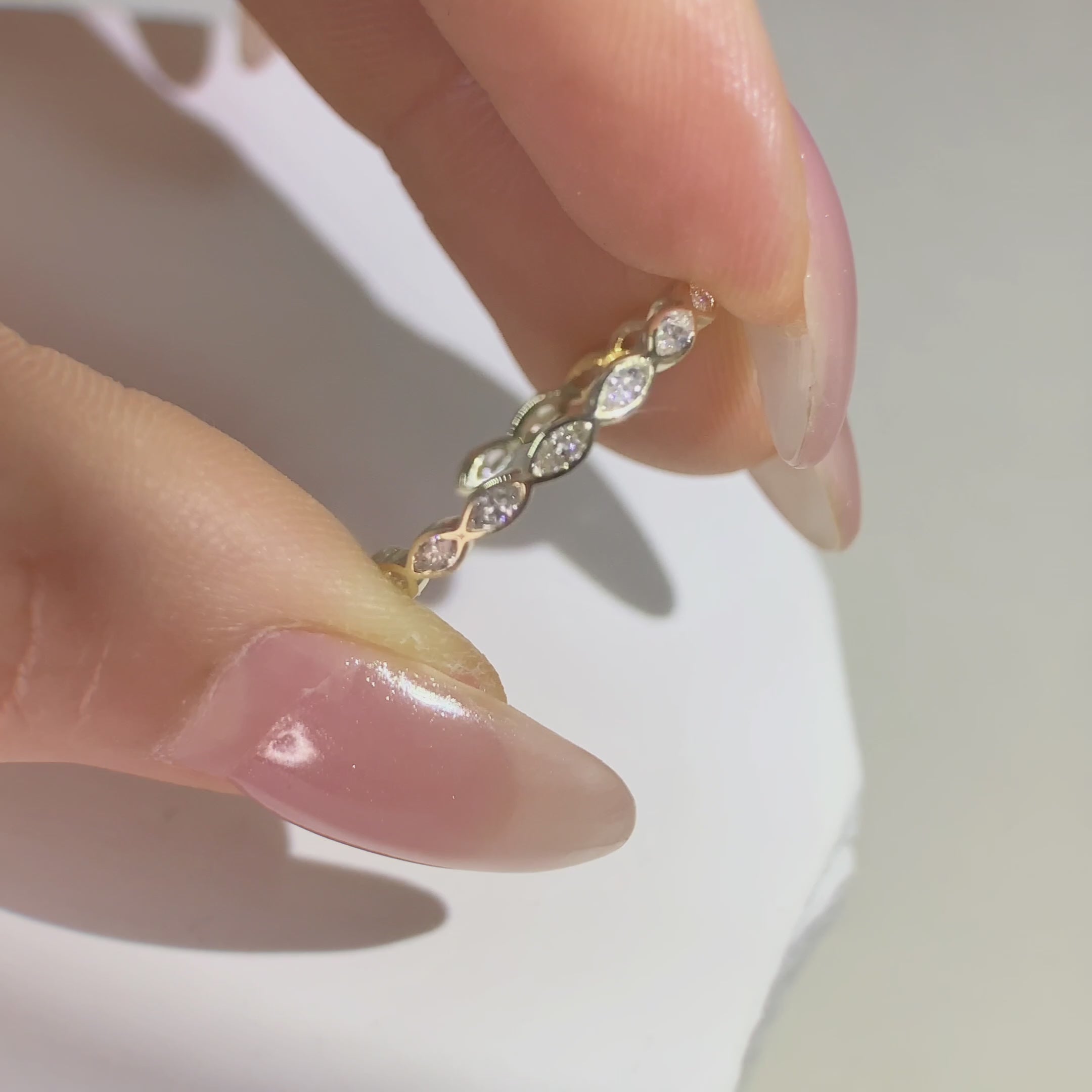 Hoding marquise cut diamond  open yellow gold  band 